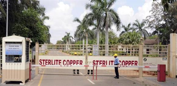A private security guard stands in front of the main gate of Sterlite Industries Ltd's copper plant in Tuticorin in Tamil Nadu.