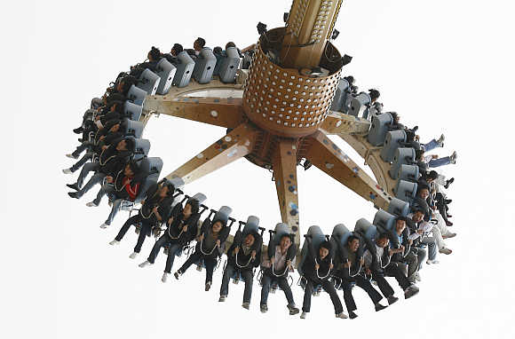 People enjoy a ride at an amusement park in Dalian, Liaoning province, China.