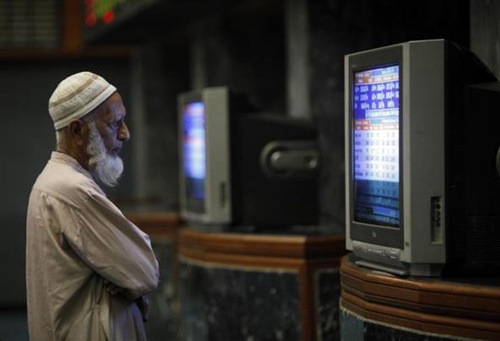 A Pakistani monitors stock prices at the Karachi Stock Exchange.
