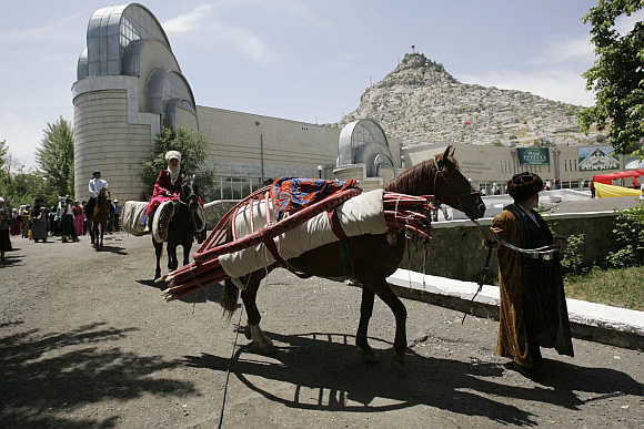 A horse carries a folded-up yurt, a traditional felt tent, as they head to a handicraft fair in Osh, 700km south of the capital Bishkek, in Kyrgyzstan.
