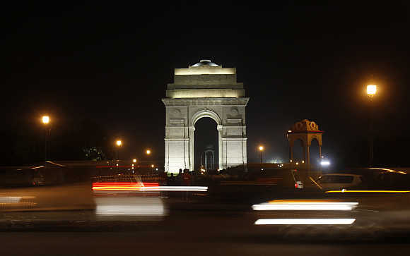 Traffic moves in front of the India Gate in New Delhi.