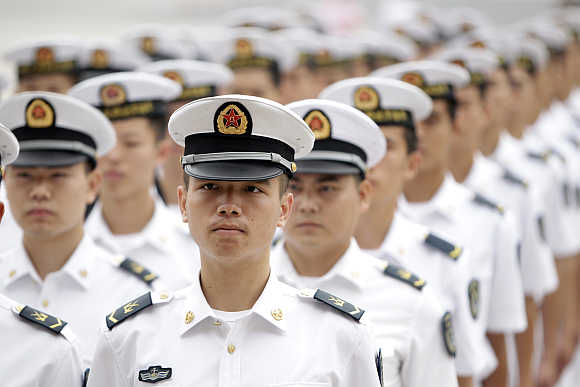People's Liberation Army navy sailors stand at the Great Hall of the People in Beijing.