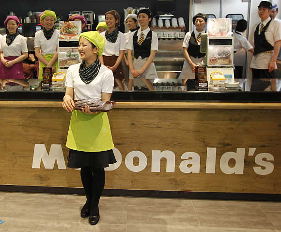 McDonald's counter staff wait for the opening of its Harajuku-Omotesando shop in Tokyo, Japan.