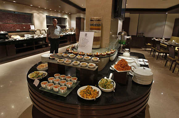 A guest walks inside a restaurant of the Four Points hotel in Ahmedabad.