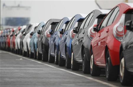 Newly produced Toyota cars are seen parked at a port.