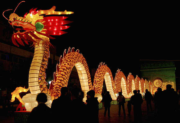 A hundred-meter-long (328 feet) lantern, featuring a dragon and made of 10,000 used compact discs and auto parts, is lit up in Hami, Xinjiang Uygur Autonomous Region.