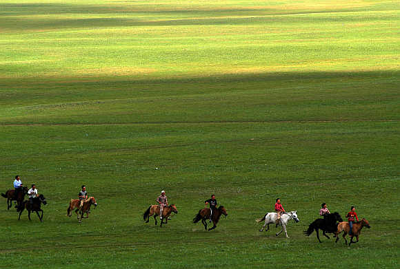 Nomads participate in a horse race on the Kerqin Grassland in Inner Mongolia.