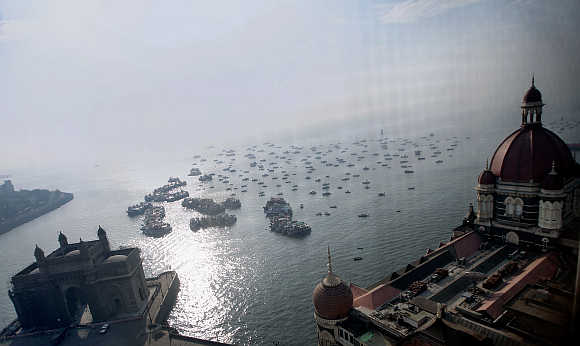 Domes of the Taj Mahal hotel and the historic Gateway of India in front of the Arabian Sea in Mumbai.