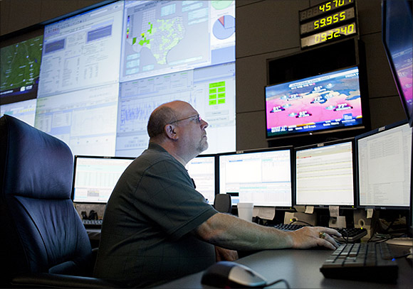 An executive monitors power use on the big screen.
