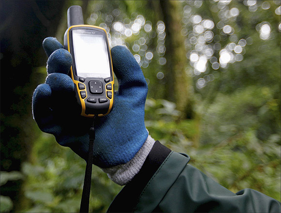 A scientist holds up a GPS device.