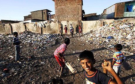 Slum children play cricket in Mumbai.