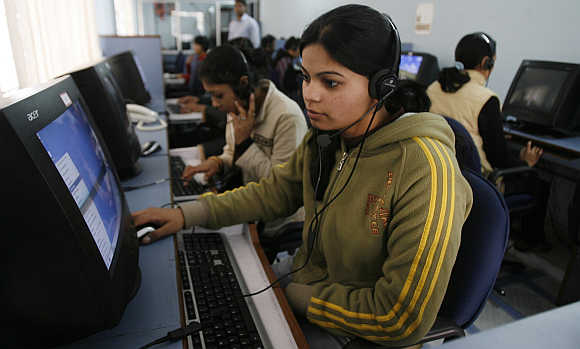 Employees at a call centre provide service support to customers, in Siliguri.