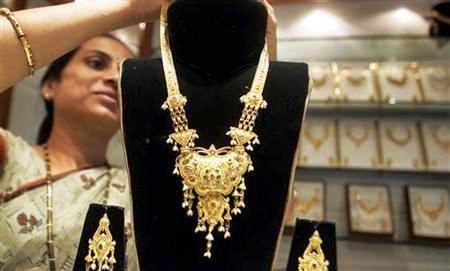A worker displays gold jewellery at a shop in Mumbai.