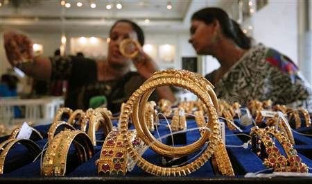 Customers look at gold bangles inside a jewellery shop in Hyderabad.