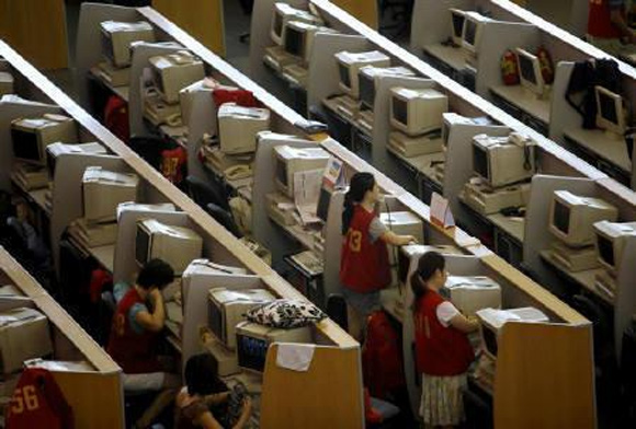 Brokers work next to their computers at the Shanghai Stock Exchange.