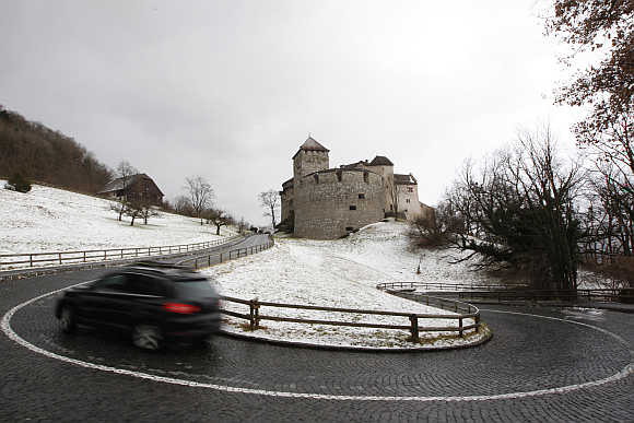 A car makes its way past Liechtenstein's castle in Vaduz.
