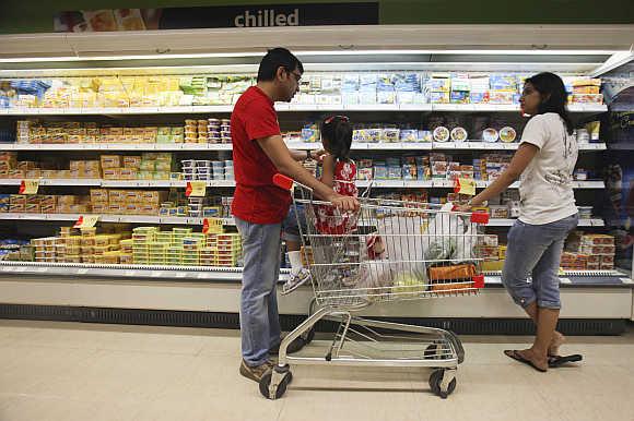 Customers shop in the chilled foods section of a Reliance Fresh supermarket in Mumbai.
