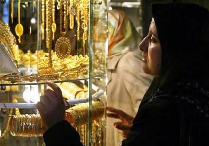 A Palestinian woman looks at gold jewellery at the traditional gold market, where people buy as well as sell gold, in Gaza City.