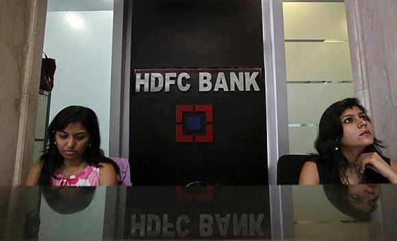 Personal bankers wait for customers at the reception of a HDFC Bank branch.