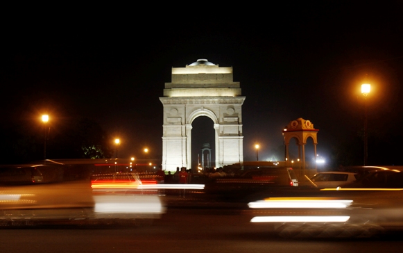 Heavy traffic moves in front of the India Gate before Earth Hour in New Delhi March 23, 2013.