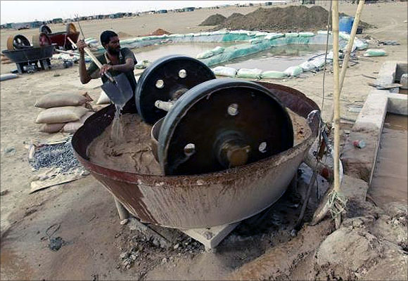 A gold mine worker uses a gold crusher at a local mine in Al-Ibedia locality at River Nile State.