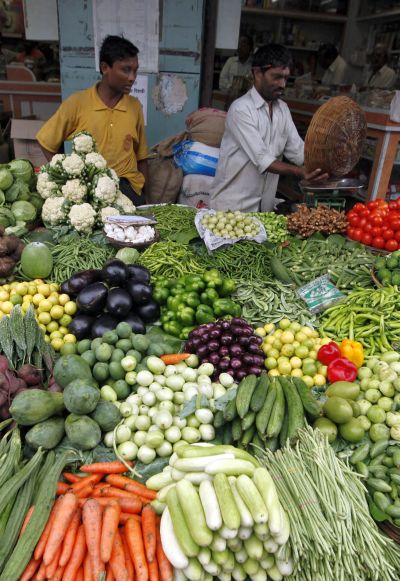 A vendor sells vegetables at a market in Mumbai.