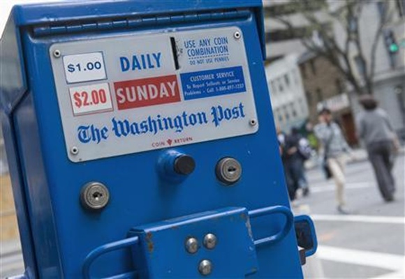 A Washington Post Company newspaper box near the company's headquarters is seen in Washington.