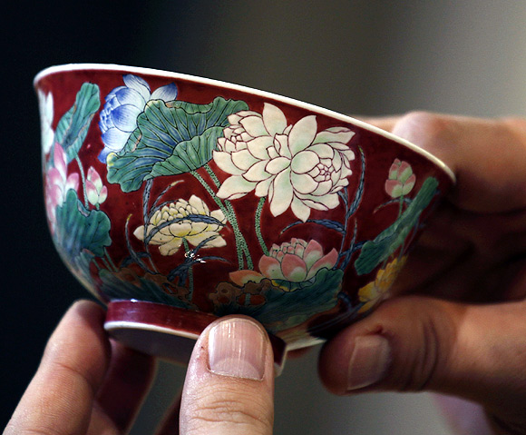 A magnificent Ruby-Ground Falangcai Double-Lotus Bowl Blue Enamel Yuzhi Mark and Period of Kangxi is shown after Hong Kong Chinese ceramics dealer William Chak has bought it for HK$74 million ($9.5 million) at Sotheby's Spring Sales in Hong Kong.