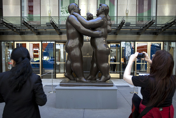 Fernando Botero's Dancers is photographed by a passer-by as it sits in front of Christie's Auction House in New York.