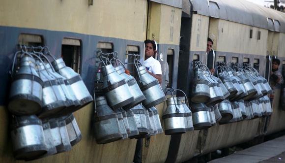 Milk containers hang from the windows of a passenger train in Ghaziabad on the outskirts of New Delhi.