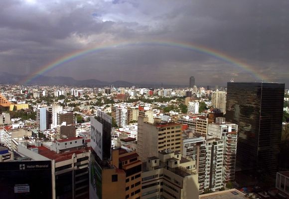 Mexico City crowned by a rainbow.