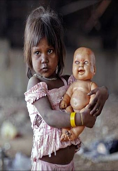 A homeless girl plays with her doll under a bridge in Mumbai.