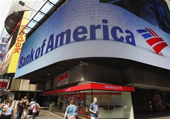 Tourists walk past a Bank of America banking center in Times Square in New York.