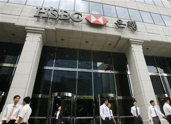 People walk past a branch office of HSBC in Seoul.