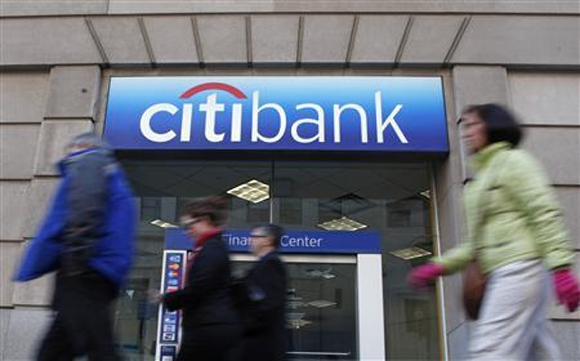 Pedestrians walk past a Citibank branch in Washington.