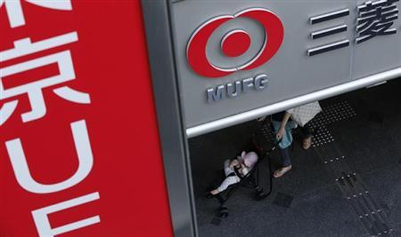 A baby on a stroller passes a branch of Mitsubishi UFJ Financial Group (MUFG) in Tokyo.