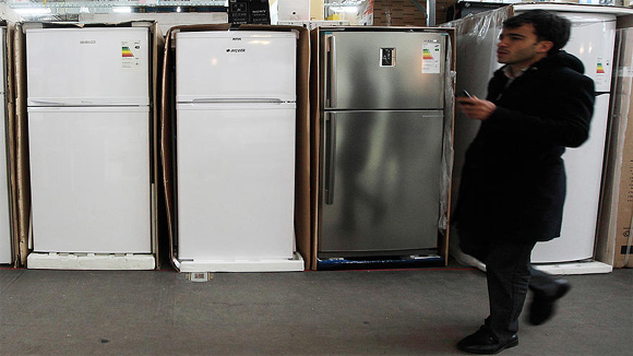 A man walks past refrigerators on sale at a store in Istanbul.
