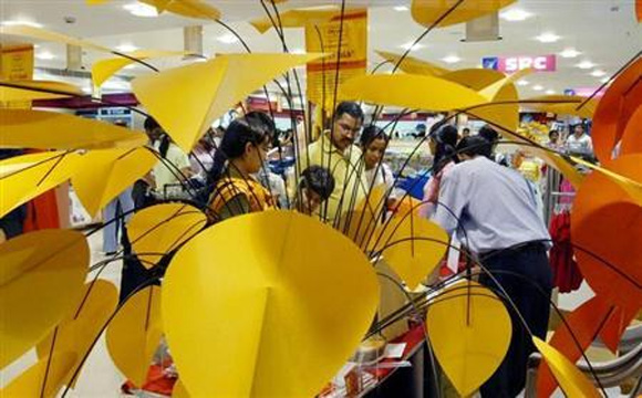 Shoppers check out products at a shopping mall in Noida.