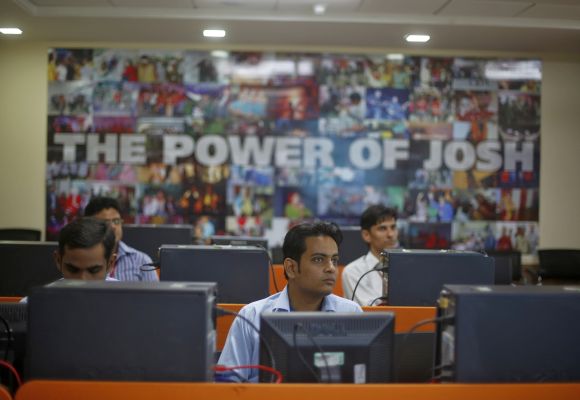 Employees attend a training session inside Tech Mahindra office building in Noida.