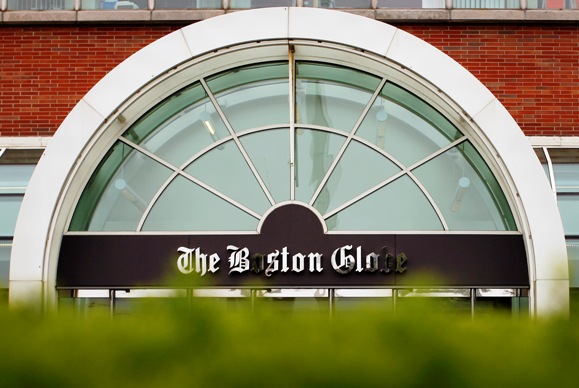 The Boston Globe's logo is seen at the entrance of the newspaper's building in Boston, Massachusetts.