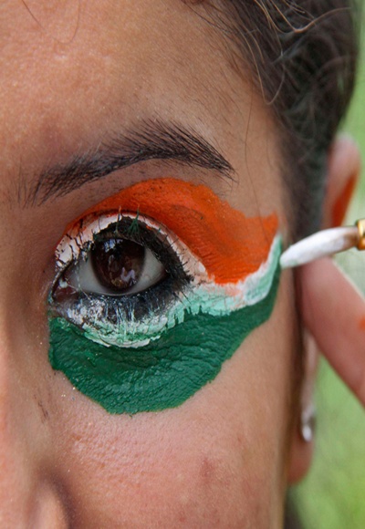 A college girl gets her eye painted in tri-colours of India's national flag in Chandigarh. 