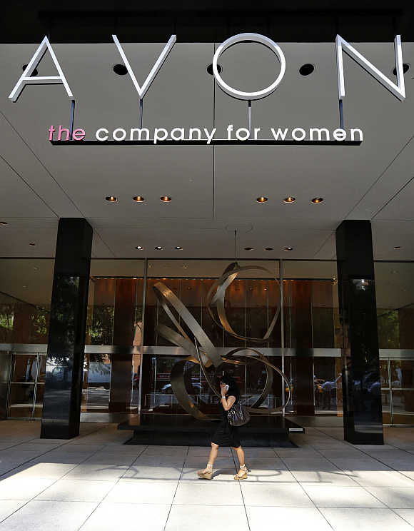 A woman walks in front of the Avon Products headquarters in midtown Manhattan area of New York.