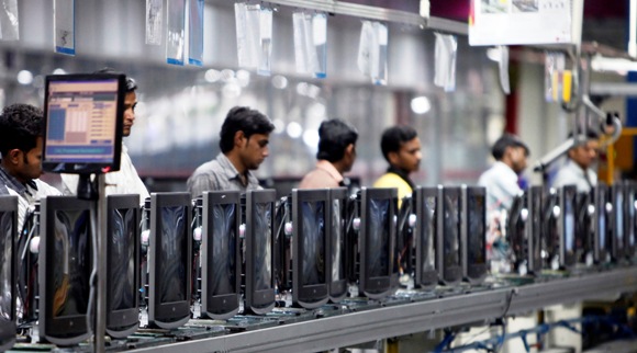 Workers at LG Electronics India Pvt Ltd. assemble television sets inside a factory at Greater Noida.