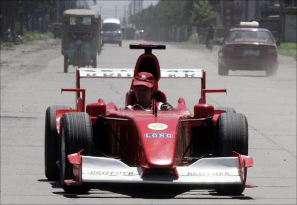 Zhao Xiuguo drives a homemade model of Formula One car in Tangshan, Hebei Province, some 180km (113 miles) east of Beijing.