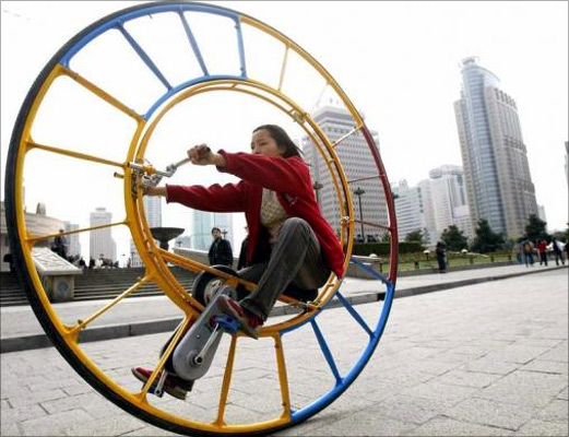 A woman rides an unicycle at a park in Shanghai.