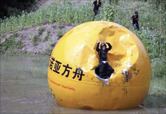 A Chinese inventor, Yang Zongfu celebrates on his six-ton (5,443 kg) ball container named Noah's Ark of China after he succeeds in a series of tests of the vessel in Yiwu, Zhejiang province.