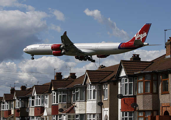 Virgin Atlantic aircraft preparesto land at Heathrow Airport in London.