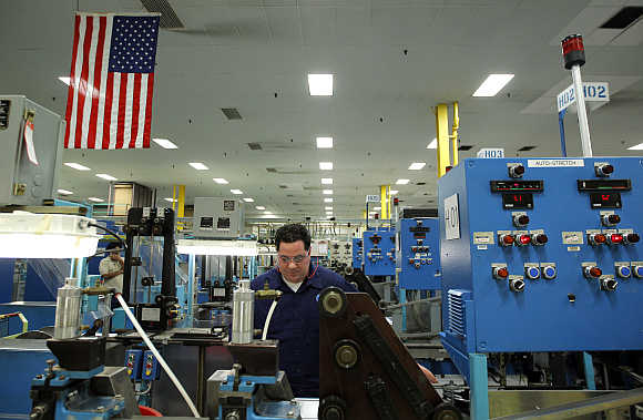 Mike DiBella monitors machines producing razor blades at Gillette's factory in Boston, Massachusetts.