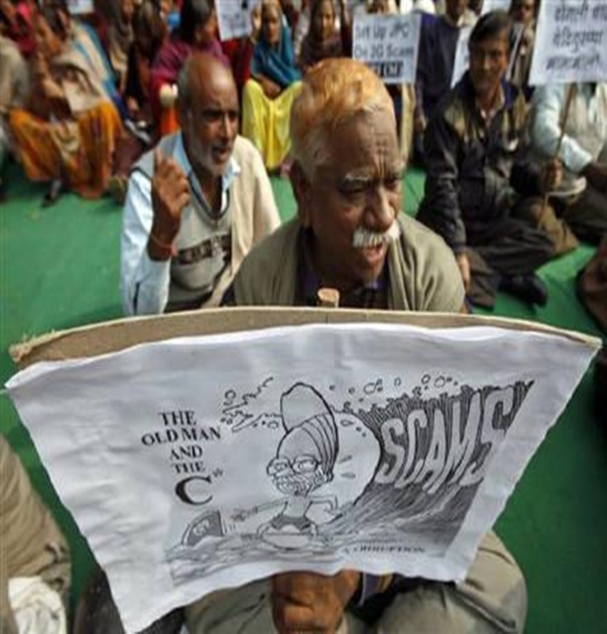 Activists hold a cartoon placard during a protest in New Delhi.