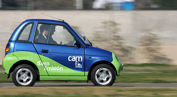 A man drives Reva Electric Car in Santiago, Chile.